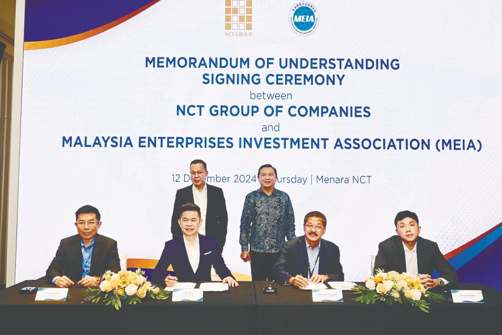 Standing are NCT Group managing director Datuk Seri Yap Ngan Choy (left) and Ng. Seated, from left, are: MEIA secretary-general Chan Kum Chung, Lo, Joe Yap and NCT Group project director Yap Chun Theng.