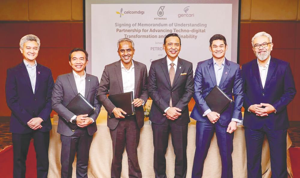 From left: Gentari head of renewables for Malaysia and Southeast Asia Syed Malek Faisal Syed Mohamad, Aadrin, Albern, Petronas project delivery and technology senior vice-president Mohd Yusri Mohamed Yusof, Gentari deputy CEO Shah Yang Razalli, CelcomDigi chief enterprise business officer Afizulazha Abdullah at the MoU signing ceremony. – CelcomDigital pic
