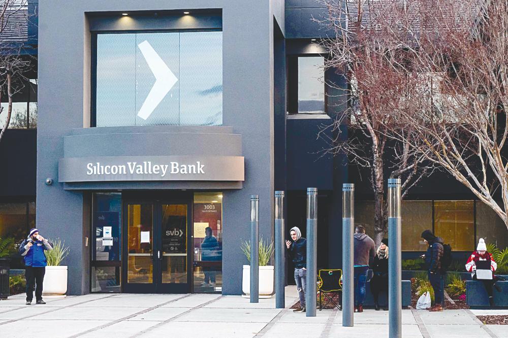 Silicon Valley Bank customers line up before the opening of a branch at its headquarters in Santa Clara, California, on Monday. The collapse of SVB is the most significant bank failure in the United States since the financial crisis of 2008. – AFPpic