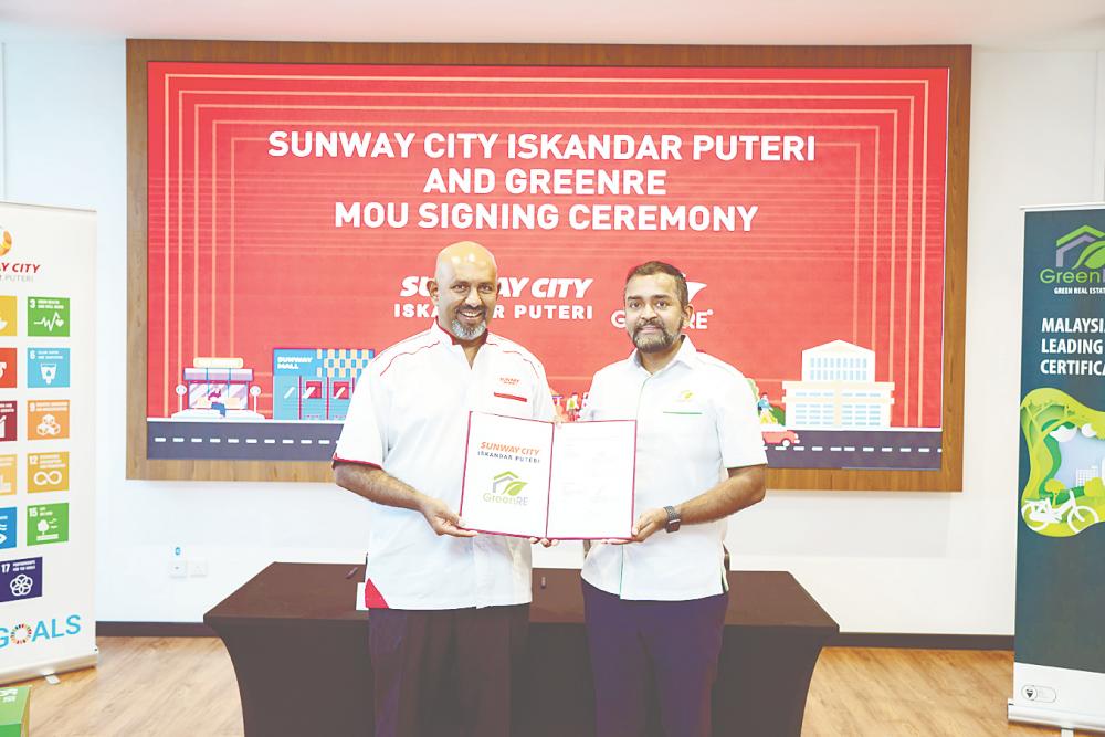 Gerard (left) and GreenRE executive director Ashwin Thurairajah formalising the partnership at the MoU-signing event.