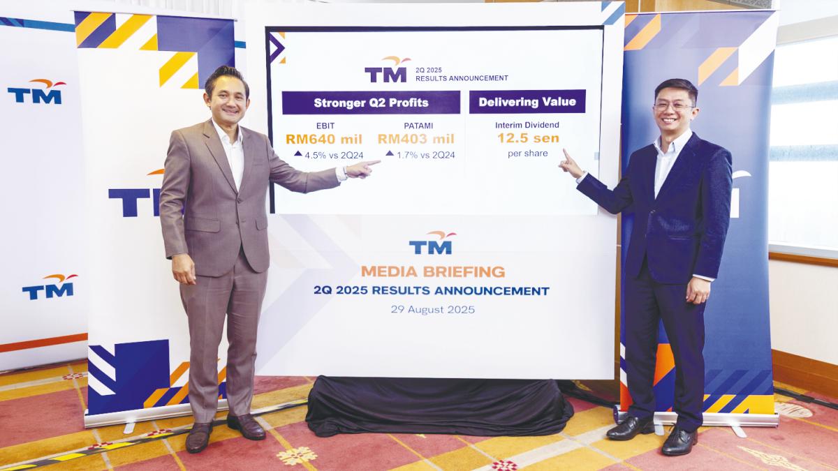 Amar Huzaimi (left) and group chief financial officer Ahmad Fairus Rahim at TM’s results briefing in Kuala Lumpur on Friday.
