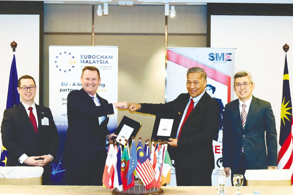 From left: Schneider, Roche, Kang and SME Association of Malaysia vice-president Yap Keng Teck at the MoU signing ceremony.