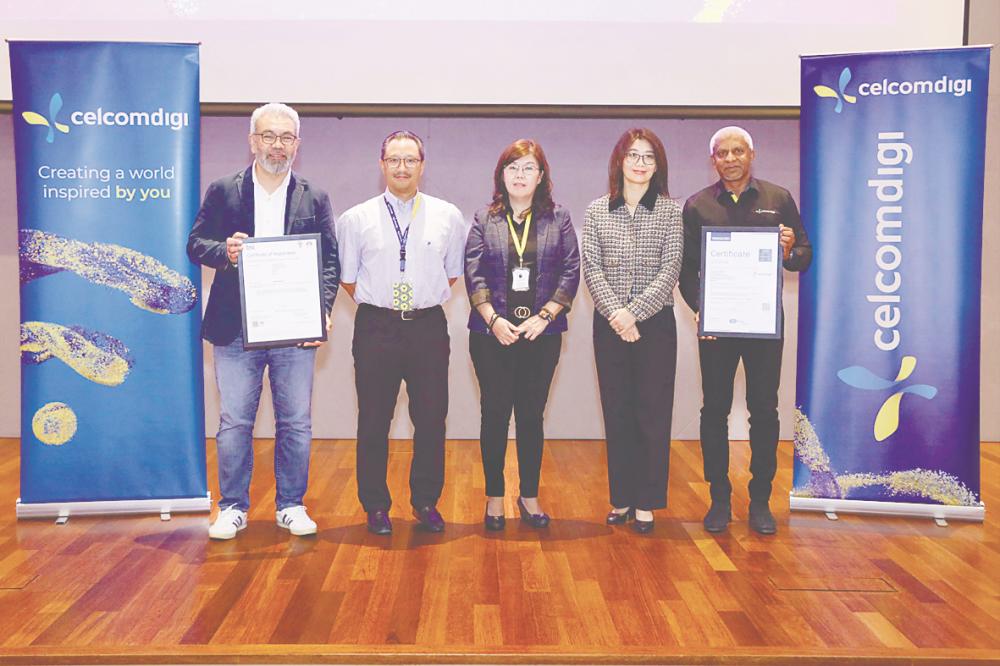 From left: CelcomDigi chief enterprise business officer Afizulazha Abdullah, Kamal, British Standards Institution Sdn Bhd managing director Evelyn Chye, TUV Nord (Malaysia) Sdn Bhd general manager Eva Soo, and CelcomDigi chief technology officer Kesavan Sivabalan at the ISO certifications conferment ceremony.