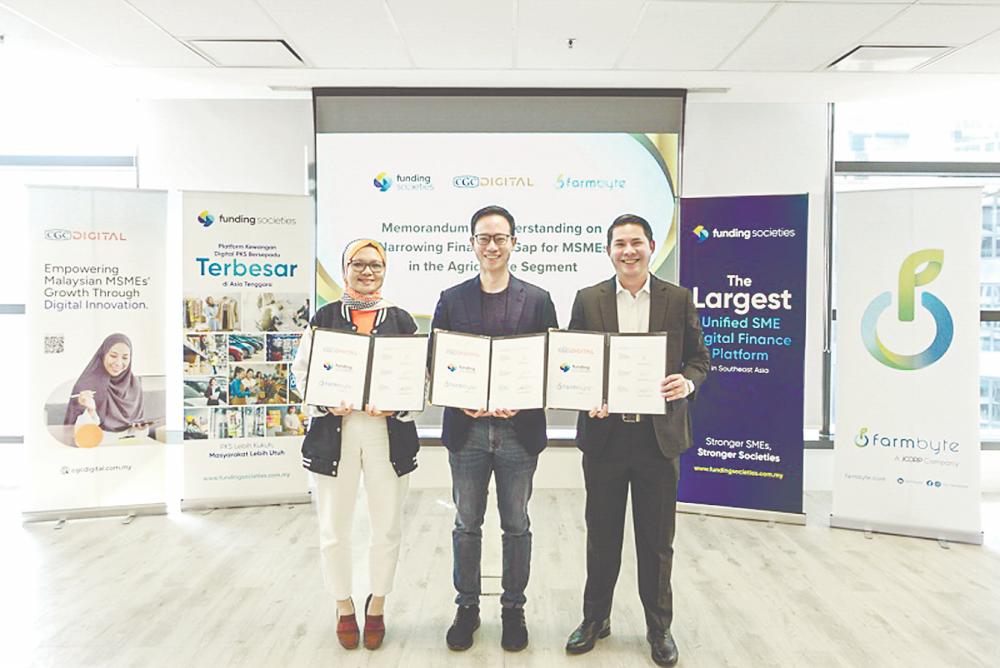 From left: Yushida Husin, Wong, and Syed Aiman Kifli after the MoU signing ceremony.