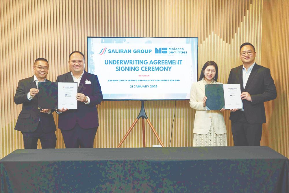 From left: Saliran Group Bhd executive director Chan Koon Wai, Liaw, Malacca Securities Sdn Bhd managing director Lim Chia Wei and co-head of corporate finance Jason Chan.