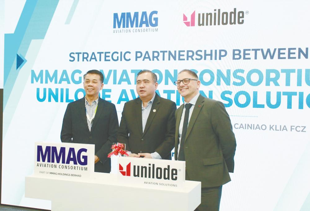 From left: MMAG Holdings chairman Tan Sri Mohd Khairul Adib Abd Rahman, Transport Minister Anthony Loke Siew Fook and Marino at the strategic partnership ceremony.