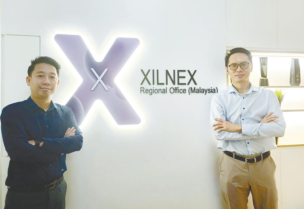 Ooi (left) with business development director Tan Wei Kit.