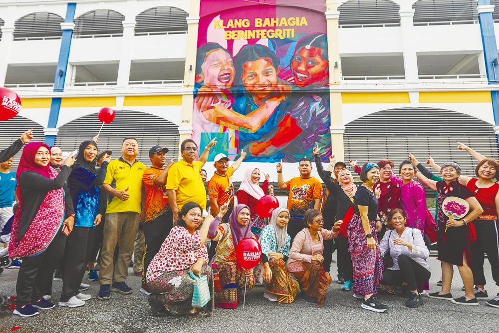 MPK council members and visitors with the artists who drew the “Klang Bahagia Berintegriti” mural at the Park &amp; Ride Komuter Klang station. – AMIRUL SYAFIQ/THESUN