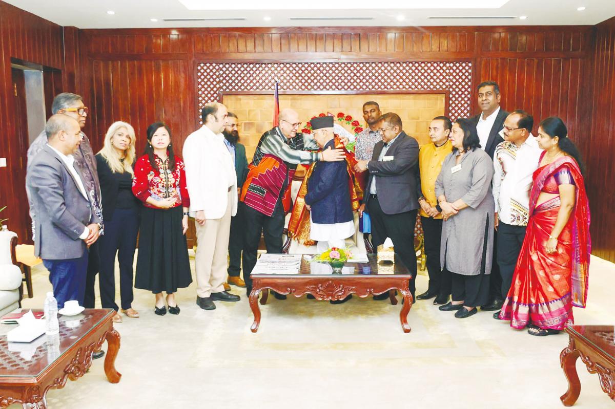 Pardip placing a ceremonial shawl on Oli on behalf of the visiting delegation.
