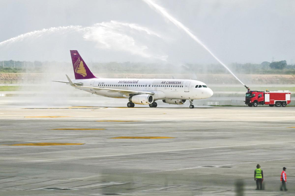 An Air Cambodia A320 given a water cannon welcome upon its arrival at the newly built Techo International Airport yesterday. – AFPPIX
