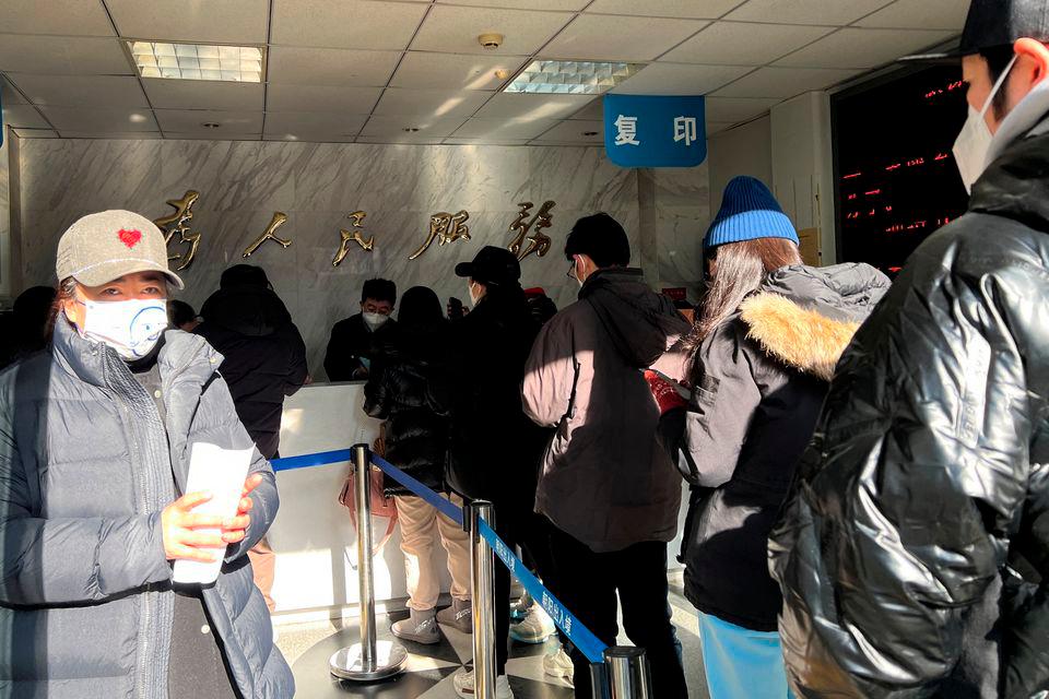 People line up at a government office for entry and exit matters which provides services including making or renewing passports or permits to go to Hong Kong, Macau and Taiwan, after China reopened borders, in Beijing, China January 9, 2023. REUTERSPIX