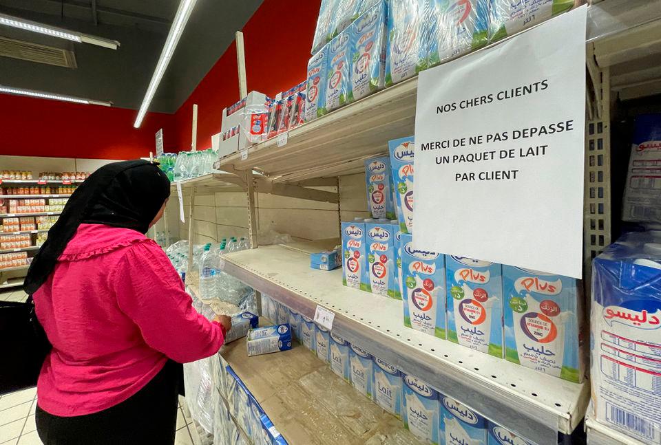 A woman stands near a sign restricting customers to buy one carton of milk, at a supermarket in Tunis, Tunisia September 3, 2022. REUTERSpix