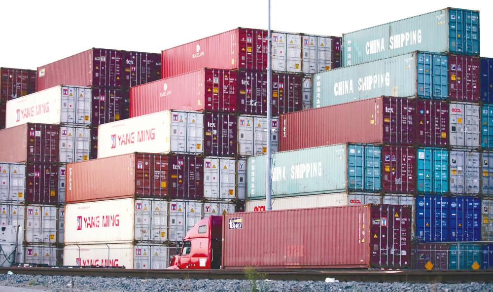 Shipping containers, some marked “China Shipping”, are stacked at the Port of Los Angeles on Nov 6. After nearly two-years of bare-knuckle battling, Washington and Beijing on Dec 13 announced a bargain to end their trade dispute. – AFPpix