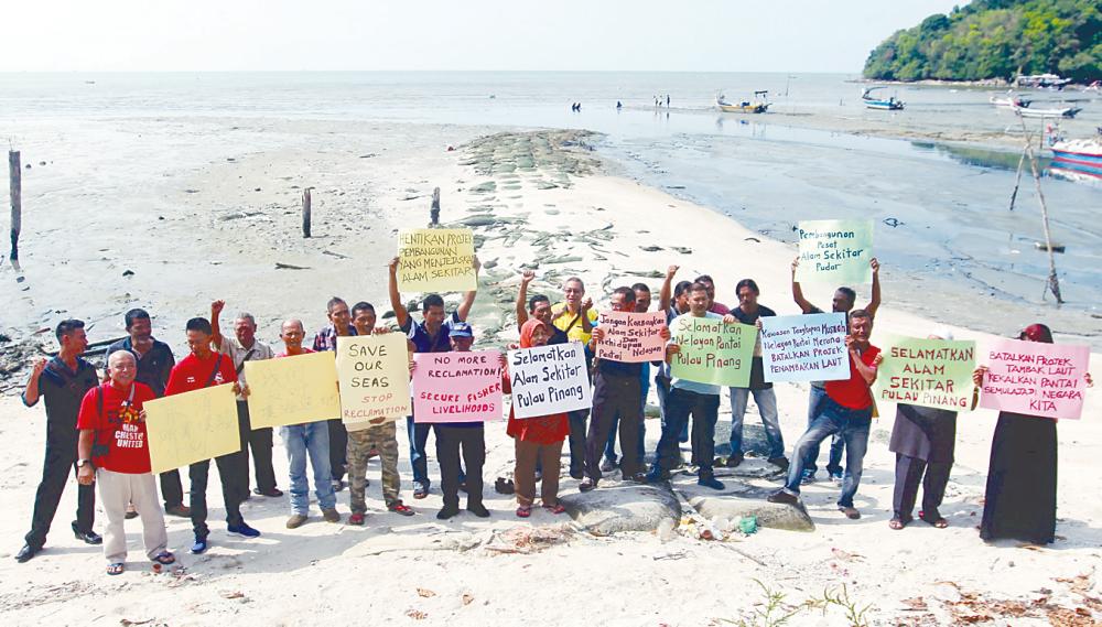 Inshore fishermen and friends protesting in Teluk Kumbar against the proposed reclamation.