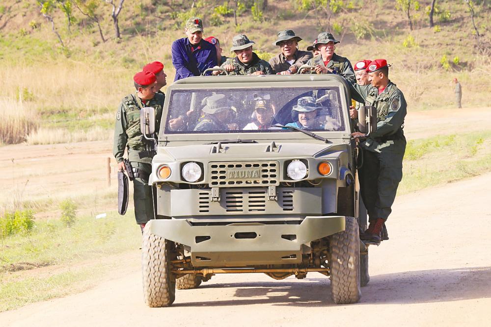 Venezuela’s President Nicolas Maduro driving a military vehicle during military exercises of cadets of the Bolivarian Military University at a training centre in El Pao, Cojedes state on Saturday. Maduro called on the armed forces to be “ready” in the event of a US military offensive. – Venezuelan Presidency/AFPpix