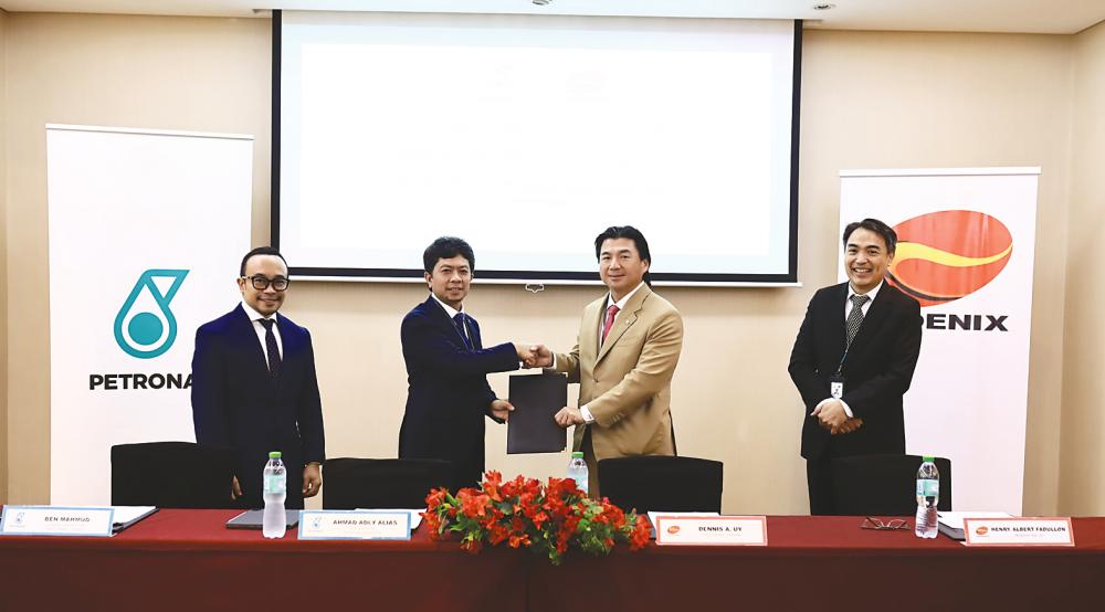 From left: Petronas head retail brand licensing and solutions Badrul Hisham Mahmud; Ahmad Adly; Phoenix Petroleum founder, chairman, director &amp; chief strategy officer Dennis Uy; and Fadullon at the signing ceremony.