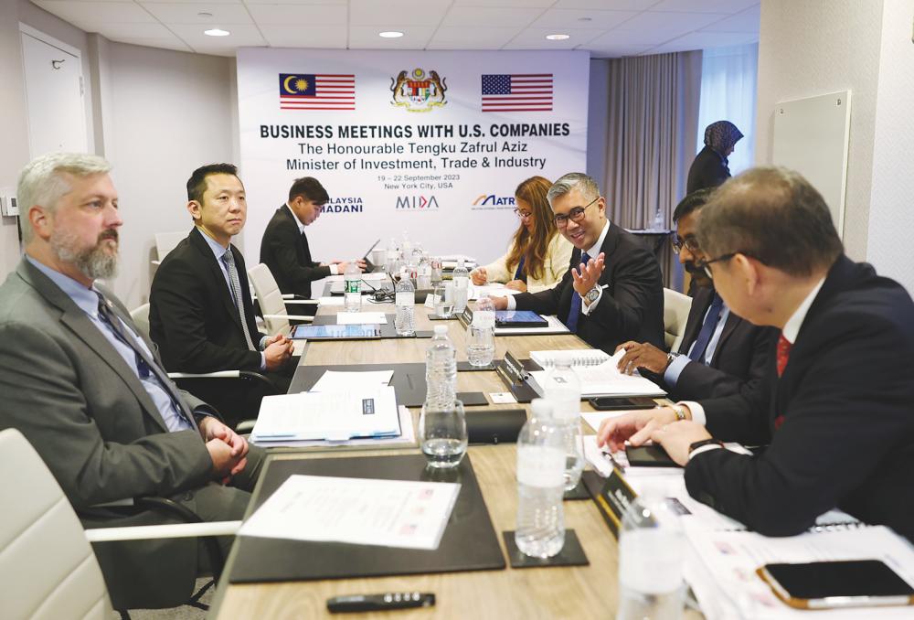Tengku Zafrul (third, right), Top Line Furniture deputy CEO Max Liaw (second, left), ministry officials and company executives during their business meeting in New York on Wednesday. – Bernamapic