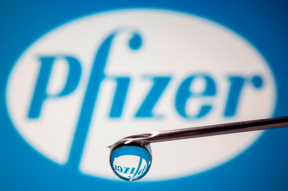 Pfizer's logo is reflected in a drop on a syringe needle in this illustration taken on November 9, 2020. -REUTERSPix