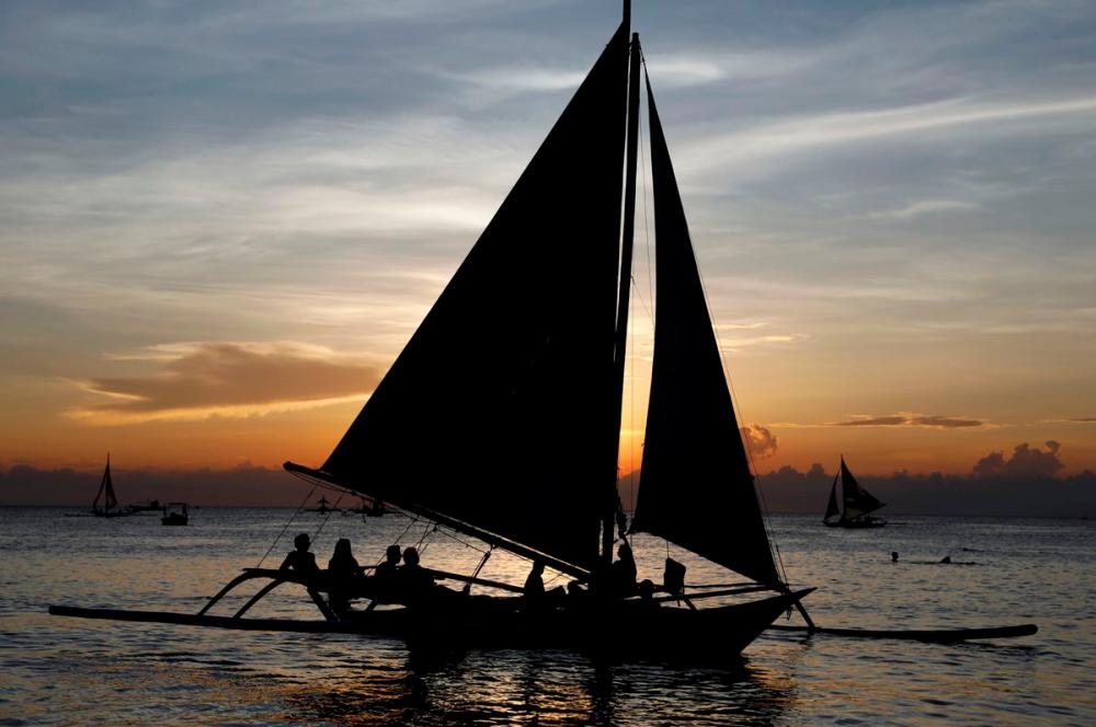 Tourists watch sunset aboard sailboats, one day before the temporary closure of the holiday island Boracay, in the Philippines, April 25, 2018. REUTERSPix