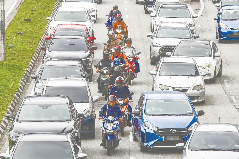 Motorcyclists should remain on the left side of roads instead of riding between cars. – ADAM AMIR HAMZAH/THESUN