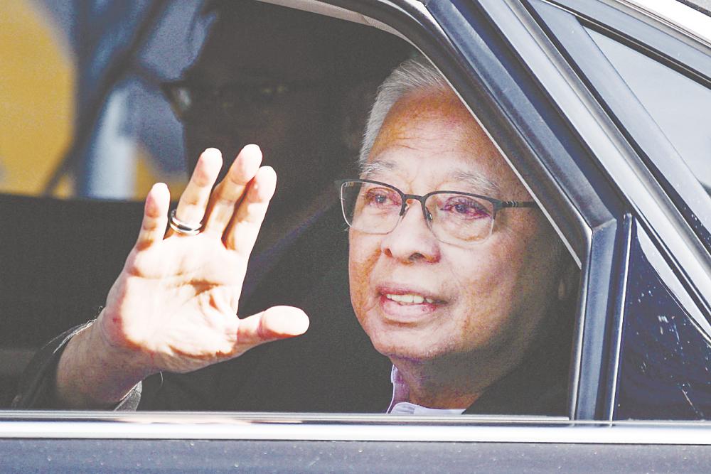 Ismail Sabri Yaakob waving to reporters as he arrives at the MACC headquarters in Putrajaya yesterday. – AFPPIX