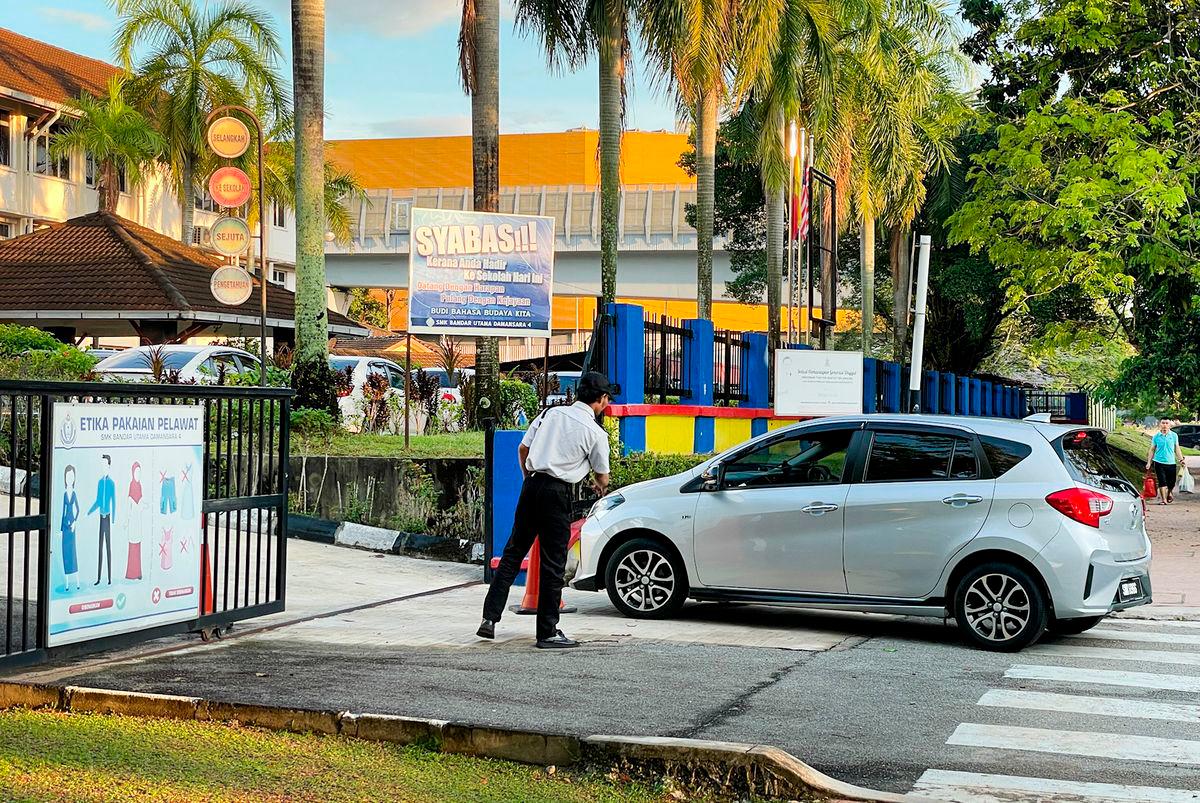 Security presence at the school yesterday as the community grapples with the tragedy that claimed a student’s life. – ADIB RAWI YAHYA/THESUN