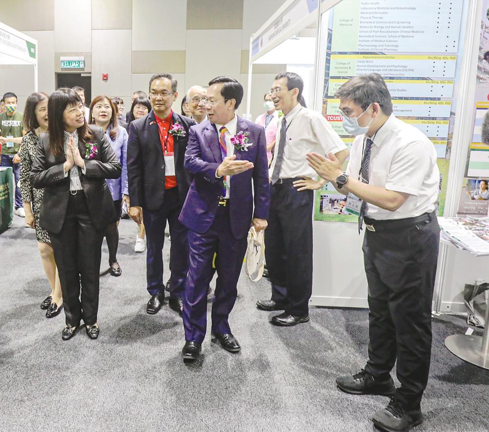 Deputy Education Minister Lim Hui Ying (left), accompanied by Faatum president Datuk Dr Tang Yong Chew (third from right), visiting some of the booths after officiating at the exhibition yesterday. – AMIRUL SYAFIQ/THESUN