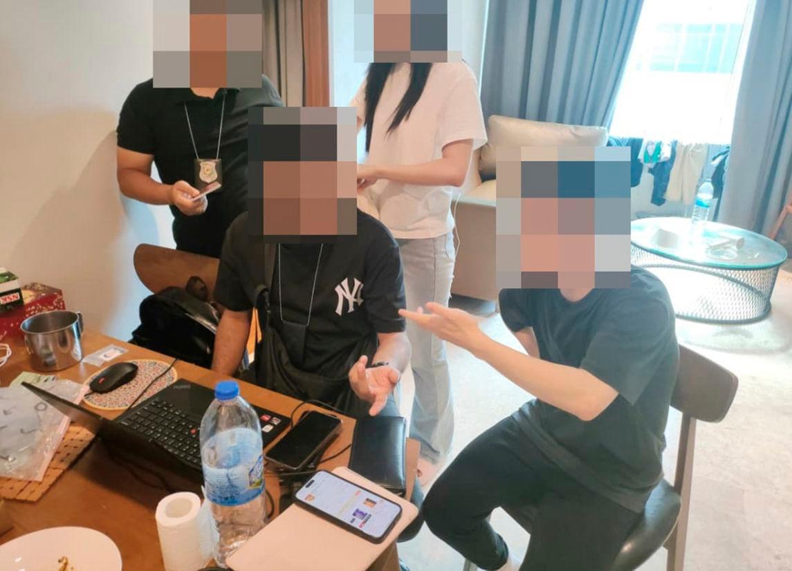 A Chinese national being questioned by enforcement officers during the raid on Oct 9. – PIC COURTESY OF IMMIGRATION DEPARTMENT