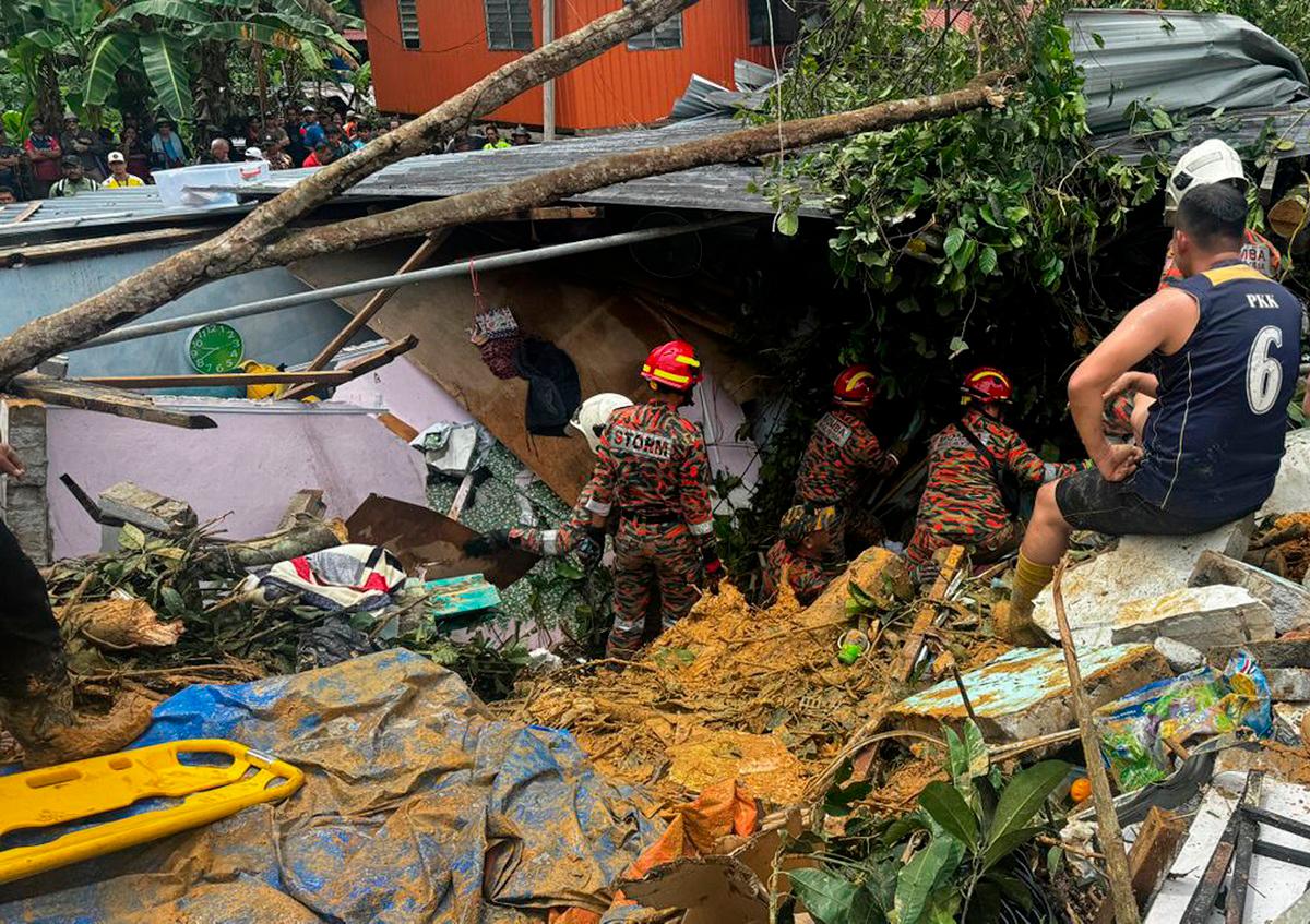 Rescue personnel searching for individuals trapped beneath the rubble of a collapsed house at Kampung Cenderakasih in Kota Kinabalu. – PIC COURTESY OF SABAH FIRE AND RESCUE DEPARTMENT