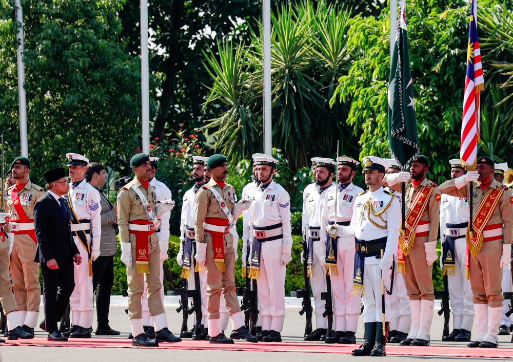 Datuk Seri Anwar Ibrahim inspects the guard of honour during a state visit at the Official Residence of the Prime Minister of Pakistan - BERNAMApix