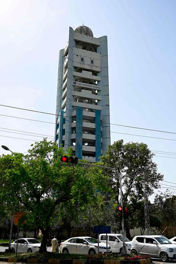 Commuters ride past the weather radar tower of Pakistan Meteorological Department (PMD) in Islamabad - AFPpix