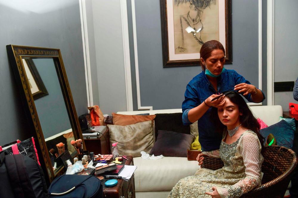 $!In this picture taken on October 15, 2020 actress Mehar Bano, one of the casts of the drama serial “Churails”, or “Witches” gets ready for one of her shoots in Karachi. AFP / Asif HASSAN