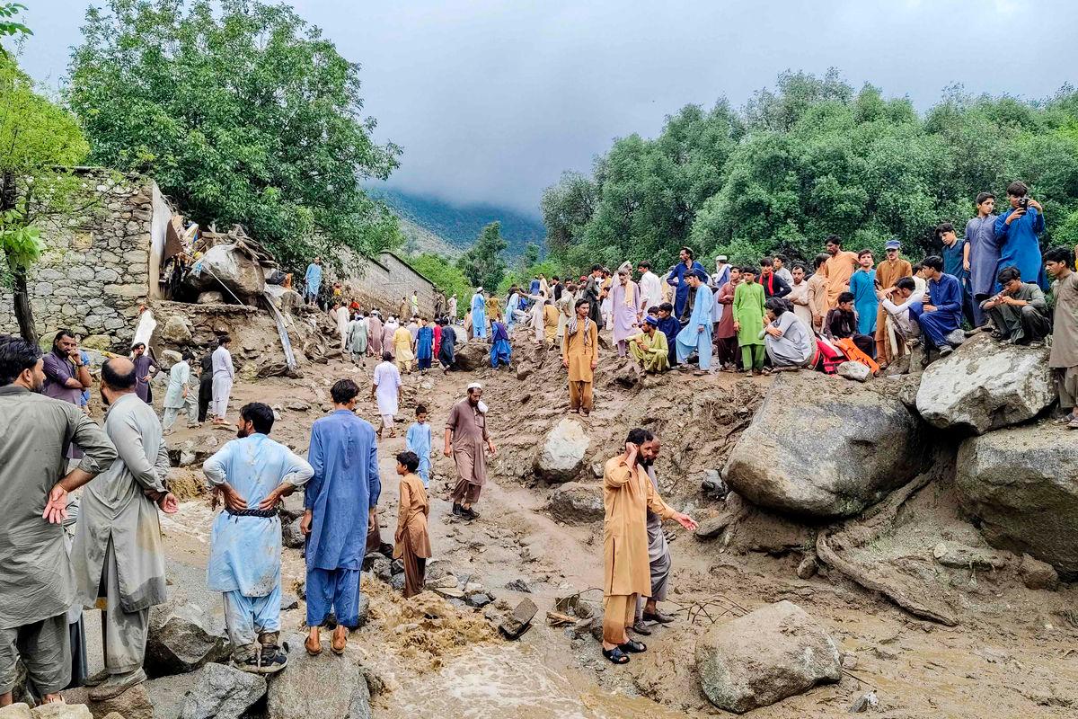 People gathered at the site of a flashflood in Salarzai Tehsil of Pakistan’s Bajaur district on August 15, 2025. Heavy monsoon rains triggered landslides and flash floods across northern Pakistan, killing at least 50 people in the last 24 hours, disaster authorities said August 15. (Photo by AFP)