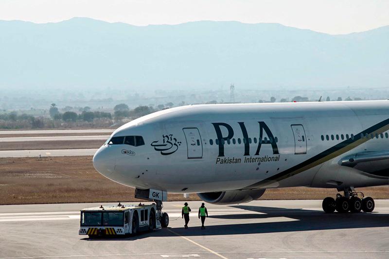 Pakistan International Airline (PIA) aircraft taxis ahead of its takeoff for Paris at the Islamabad International Airport on January 10, 2025, as EU authorities lift a four-year ban on the state airline. Pakistan's state-owned airline, plagued by a history of deadly crashes and a pilot license scandal, resumed flights to Europe after a four-year ban was lifted by EU regulators. - Farooq NAEEM / AFP