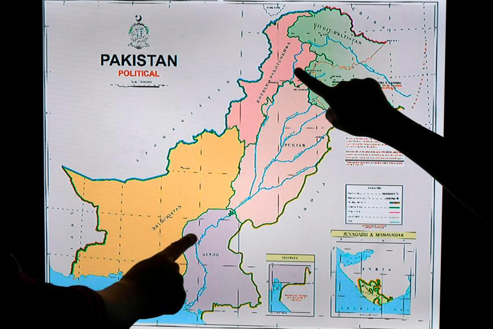 Journalists look at Pakistan's new political map on a screen at the Daily Metro Watch newspaper offices in Islamabad on Aug 4, 2020. — AFP