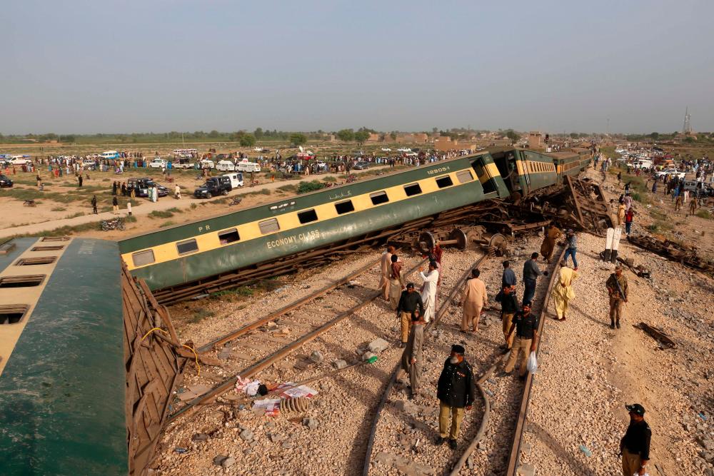 Police officials inspect the carriages at the accident site following the derailment of a passenger train in Nawabshah on August 6, 2023. AFPPIX