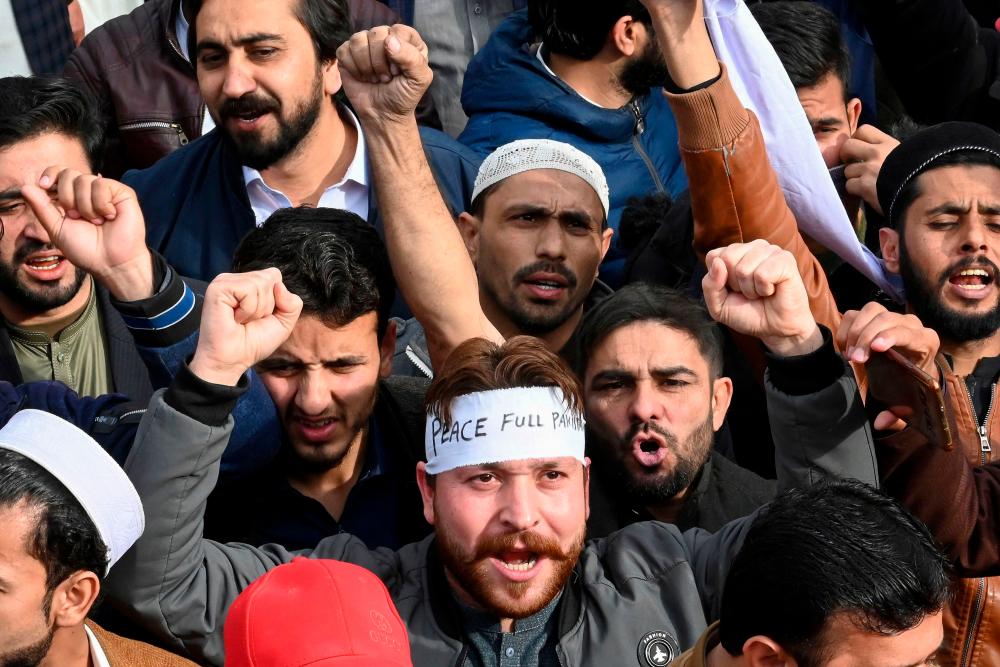 Supporters of former Pakistan’s prime minister Imran Khan chant slogans during a peace rally following a mosque suicide blast inside police headquarters, in Peshawar on February 3, 2023. AFPPIX
