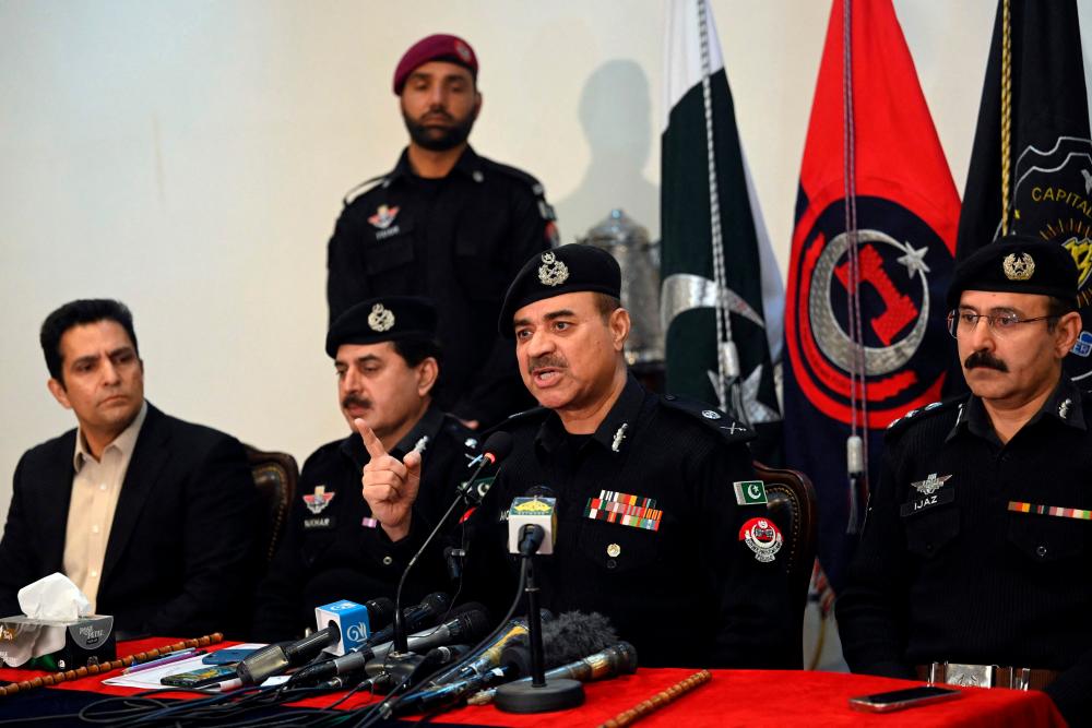 Moazzam Jah Ansari (C), head of the Khyber-Pakhtunkhwa province police force, speaks during a press conference at the Police Headquarters in Peshawar on February 2, 2023. AFPPIX