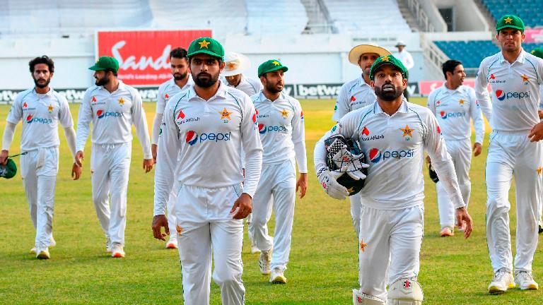 Babar Azam (left) and Mohammad Rizwan (right) of Pakistan lead teammates off the field at the end of day 3 of the 2nd Test against West Indies at Sabina Park, Kingston, Jamaica – AFPPIX
