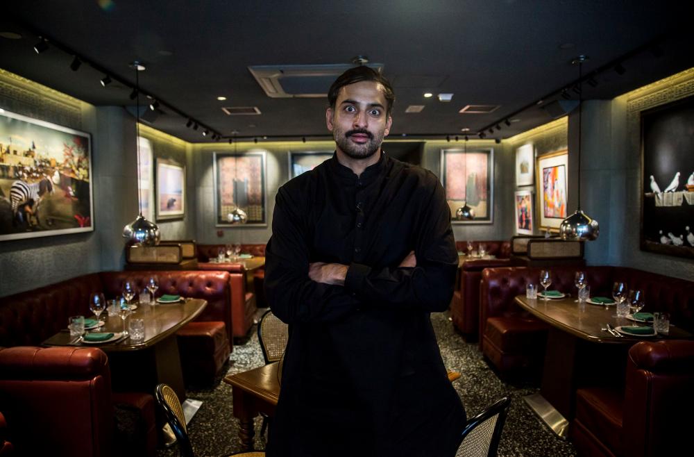 Hong Kong restaurateur Asim Hussain posing for a photo in his restaurant, the New Punjab Club, in Hong Kong.