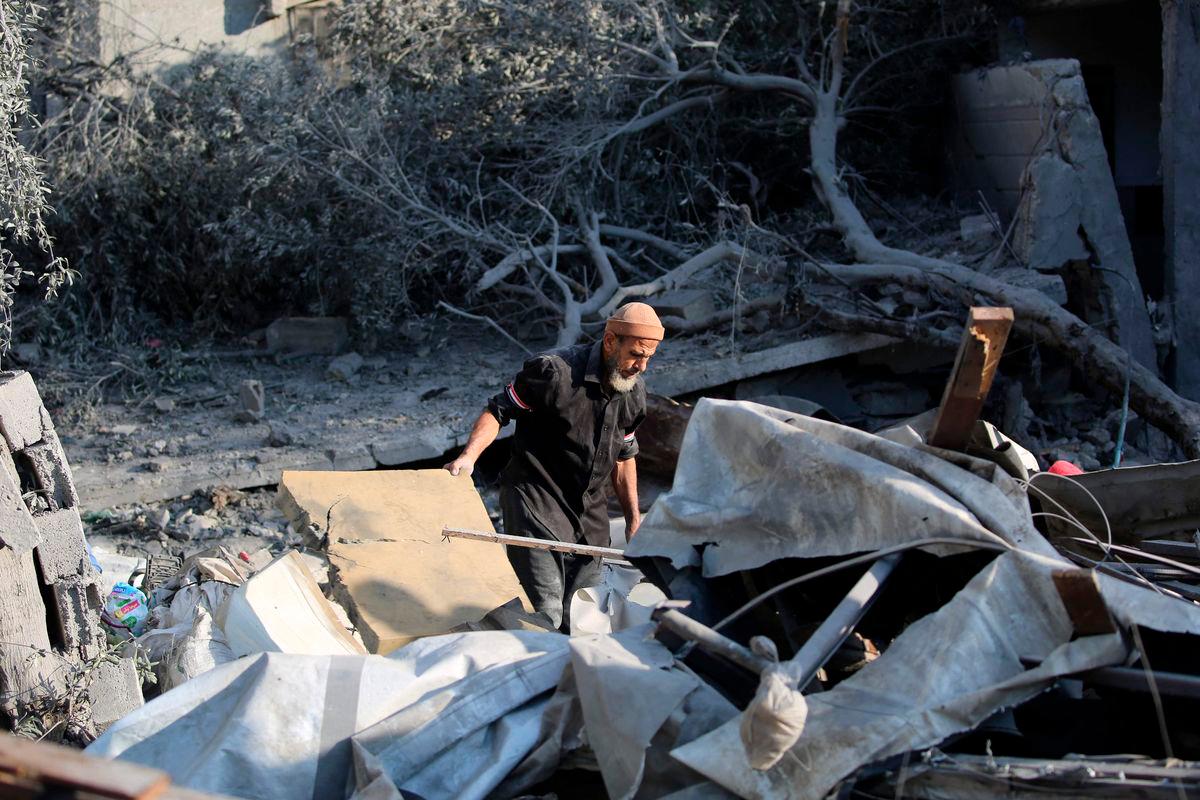 A Palestinian man checks the damage in the aftermath of an overnight Israeli strike that hit Nuseirat in the central Gaza Strip on July 13, 2025. (Photo by Eyad BABA / AFP)