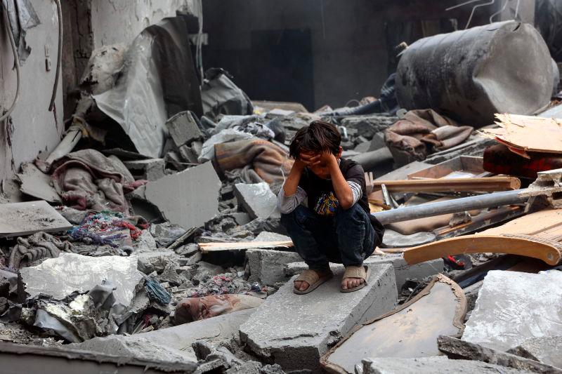 A Palestinian boy squats on the rubble of a building at the site of an Israeli strike on a residential area in Gaza City’s Shujaiyya neighbourhood, on April 9, 2025. AFPpix