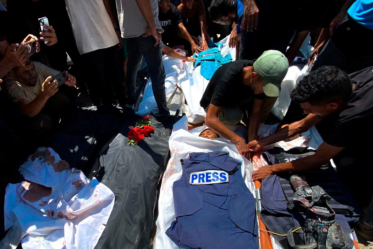 People mourn over the bodies of Palestinian journalists killed in an Israeli strike on Nasser Hospital, ahead of their funeral in Khan Yunis in the southern Gaza Strip on August 25, 2025. - AFPpix