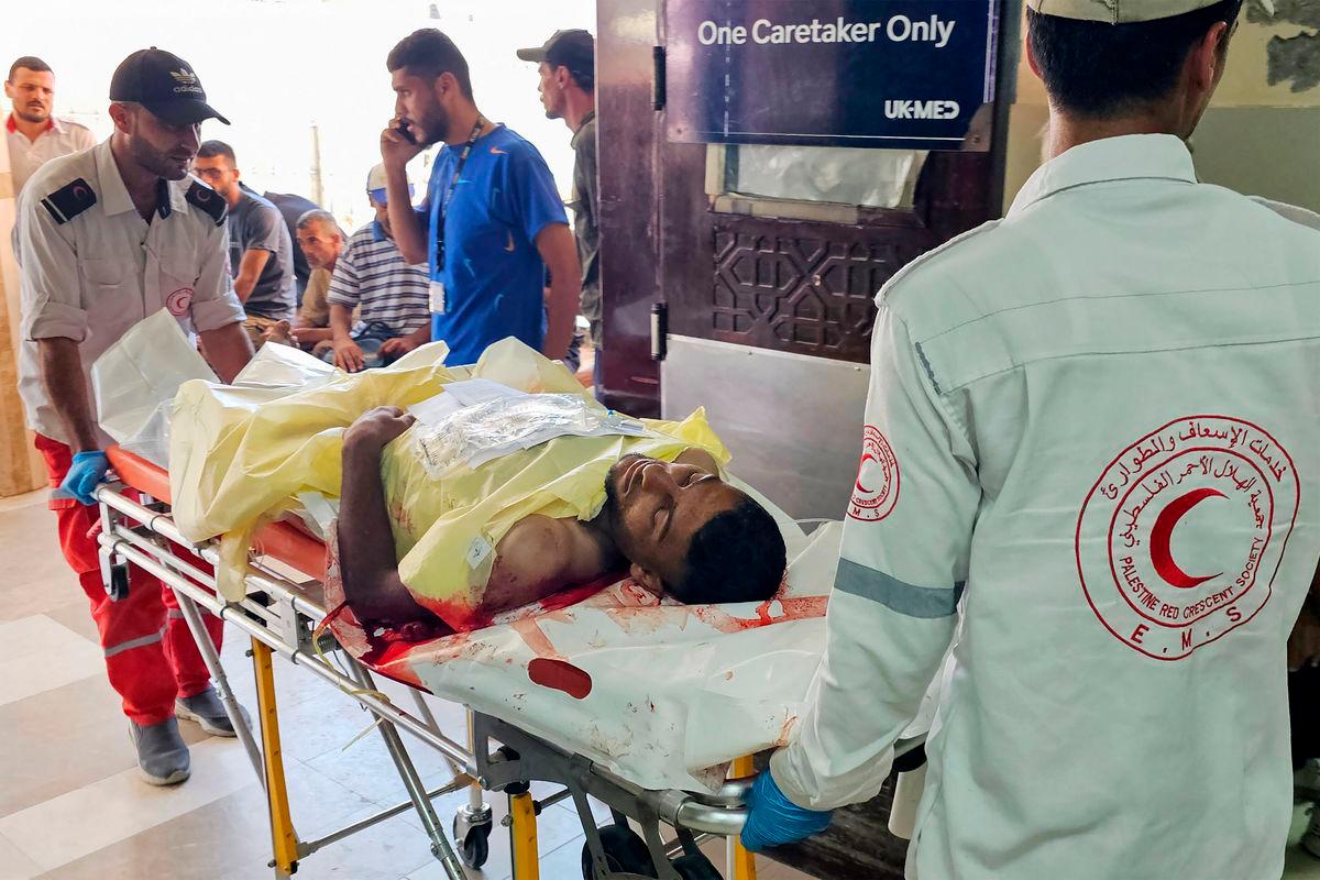 A Palestinian man who was wounded while attempting to get aid at the Rafah corridor receives treatment at the the Nasser Hospital in Khan Yunis on July 7, 2025. (Photo by AFP)