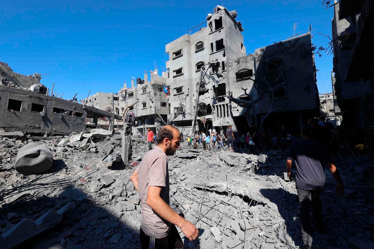 Palestinians inspect the damage after an Israeli strike in the Al-Bureij camp in the central Gaza Strip on July 4, 2025. (Photo by Eyad BABA / AFP)
