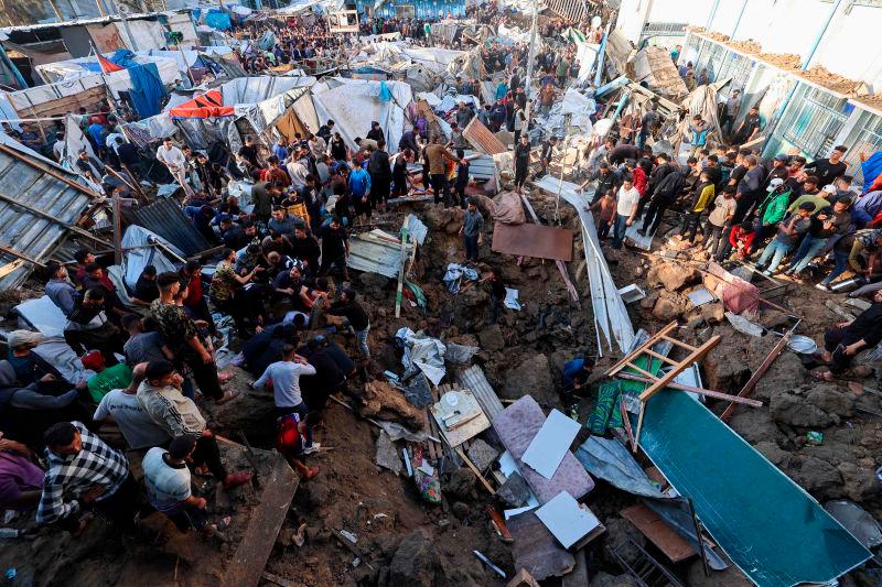 People search for survivors in a crater at the site of an Israeli strike at a UNWRA school housing displaced Palestinians at the Bureij camp for refugees in the central Gaza Strip on May 6, 2025.. AFPpix