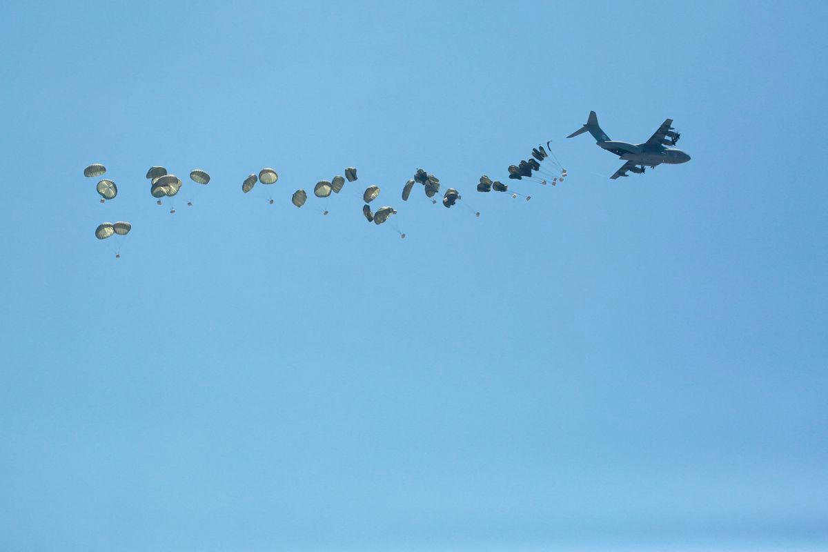 A picture taken from Northern Gaza's Jabalia shows an airplane conducting an airdrop of aid above the Israel-besieged Palestinian territory on August 1, 2025. - AFPPIX