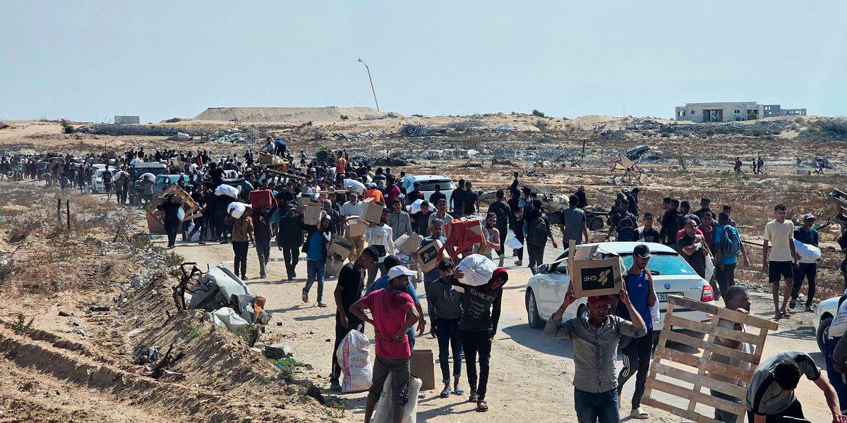 Displaced Palestinians walk along a road to receive humanitarian aid packages from a US-backed foundation in Rafah in the southern Gaza Strip on June 5, 2025. - AFPPIX