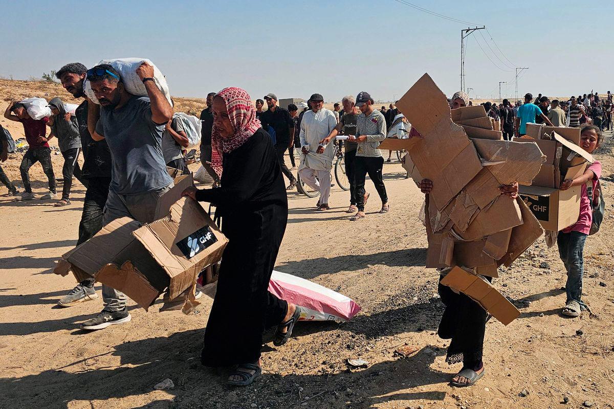 Displaced Palestinians walk along a road to receive humanitarian aid packages from a US-backed foundation in Rafah in the southern Gaza Strip on June 5, 2025. - AFPPIX