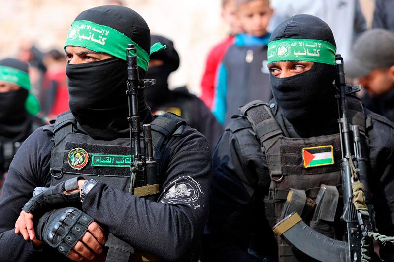 Fighters of the Ezzedine al-Qassam Brigades, Hamas's armed wing, attend the funeral of two fighters in Gaza City on January 24, 2025, after a ceasefire deal in the war between Israel and Hamas in the coastal Palestinian territory. A senior Hamas official told AFP that his group will provide on January 24, the names of four Israeli women hostages to be freed the following day as part of a second release under the ceasefire with Israel. The truce, the second in the more than 15 months of war, began on January 19, with the first three hostages released in exchange for around 90 Palestinian prisoners. - Omar AL-QATTAA / AFP